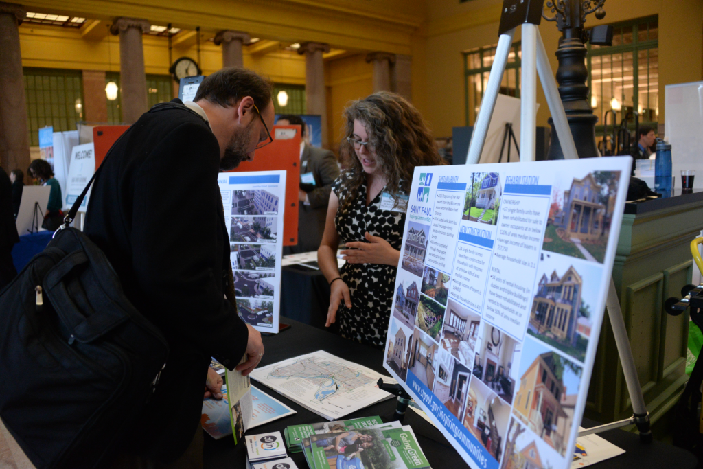 Talking about the results of the Saint Paul Streetcar Feasibility Study with a community member at the Great River Gathering. Photo by Jeff Syme.