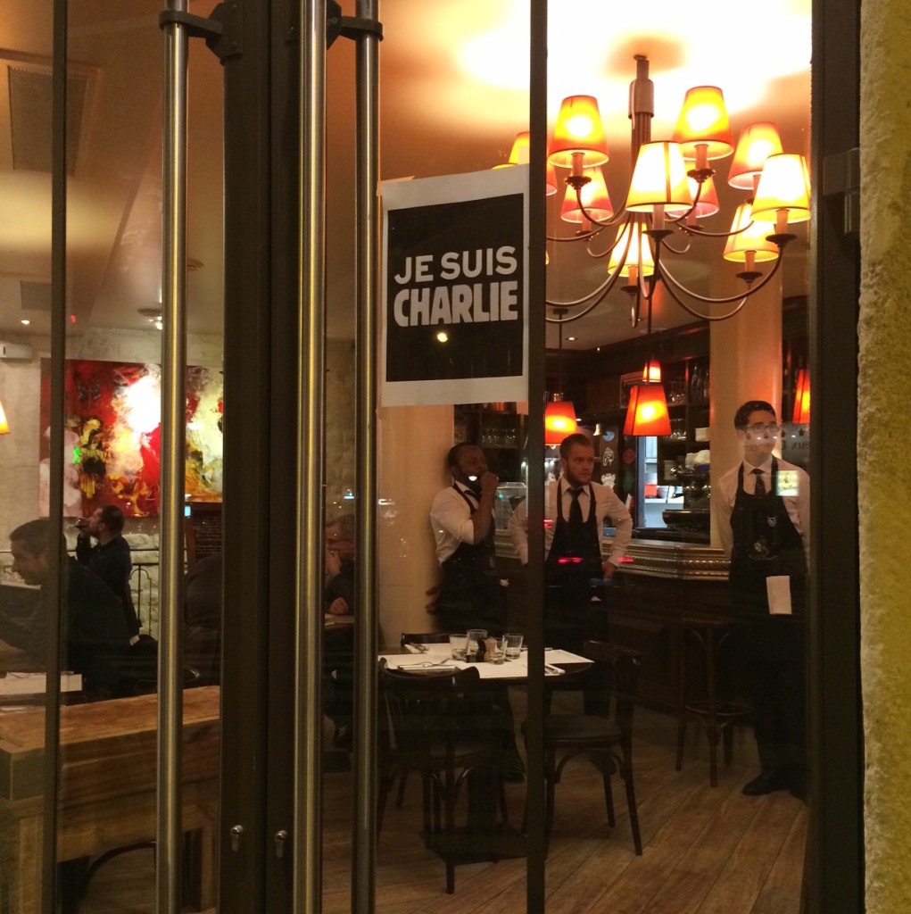 The doors of a cafe with "Je Suis Charlie" signs